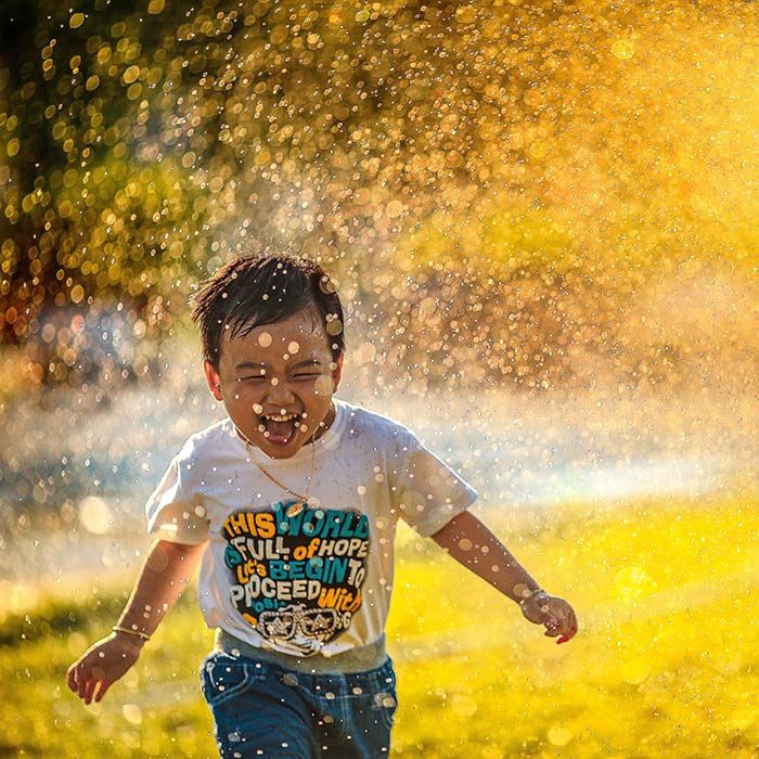 Happy child running through water